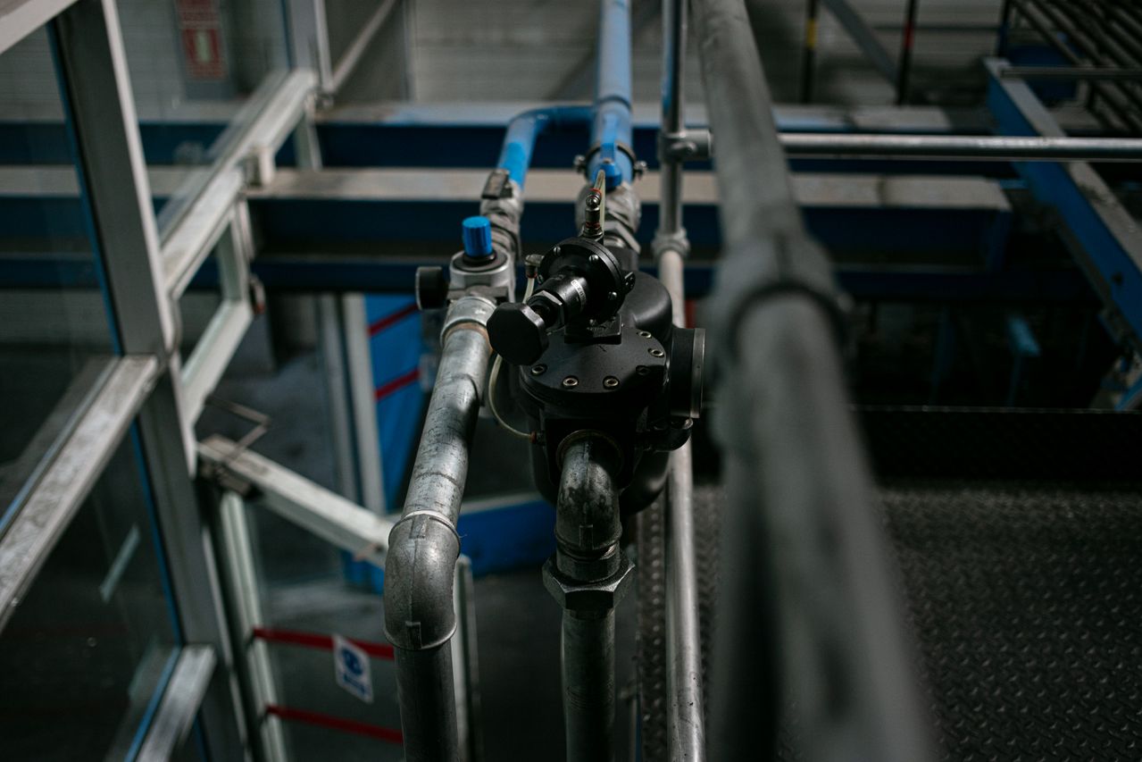 Metal pipes and control valves inside an industrial facility